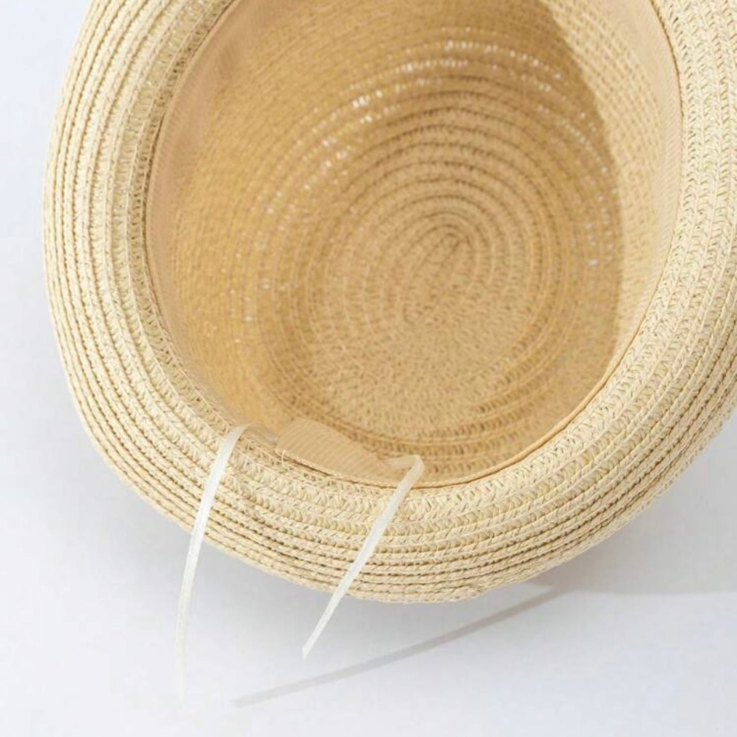 Close-up of a baby Panama hat made of straw that is adjustable