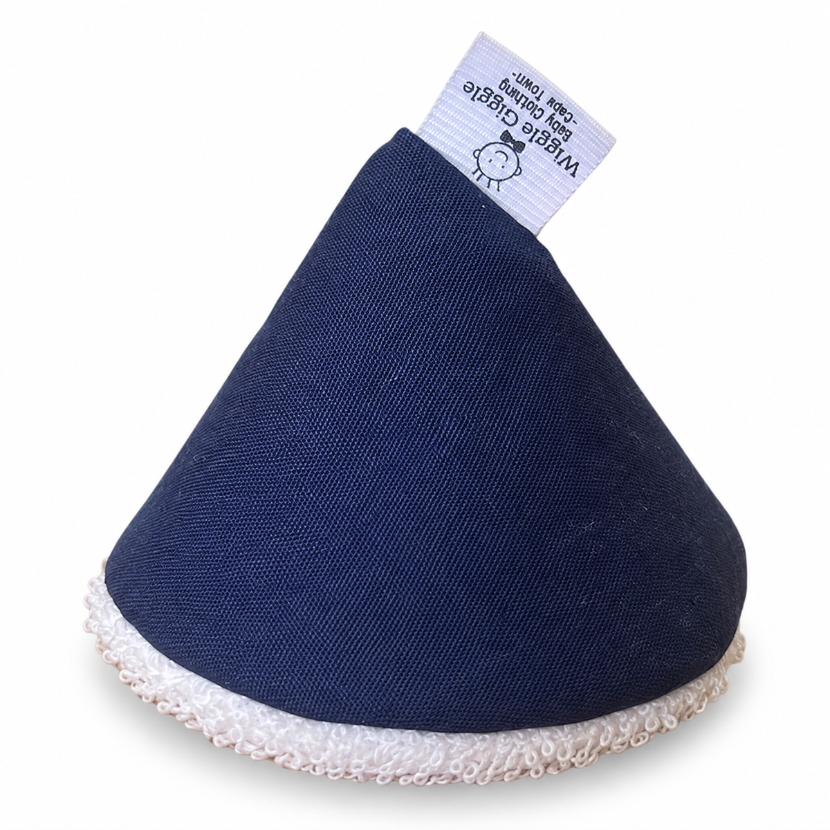 A cone-shaped pee pee teepee in navy blue fabric with a textured white toweling sticking out and a white fabric tag at the top.