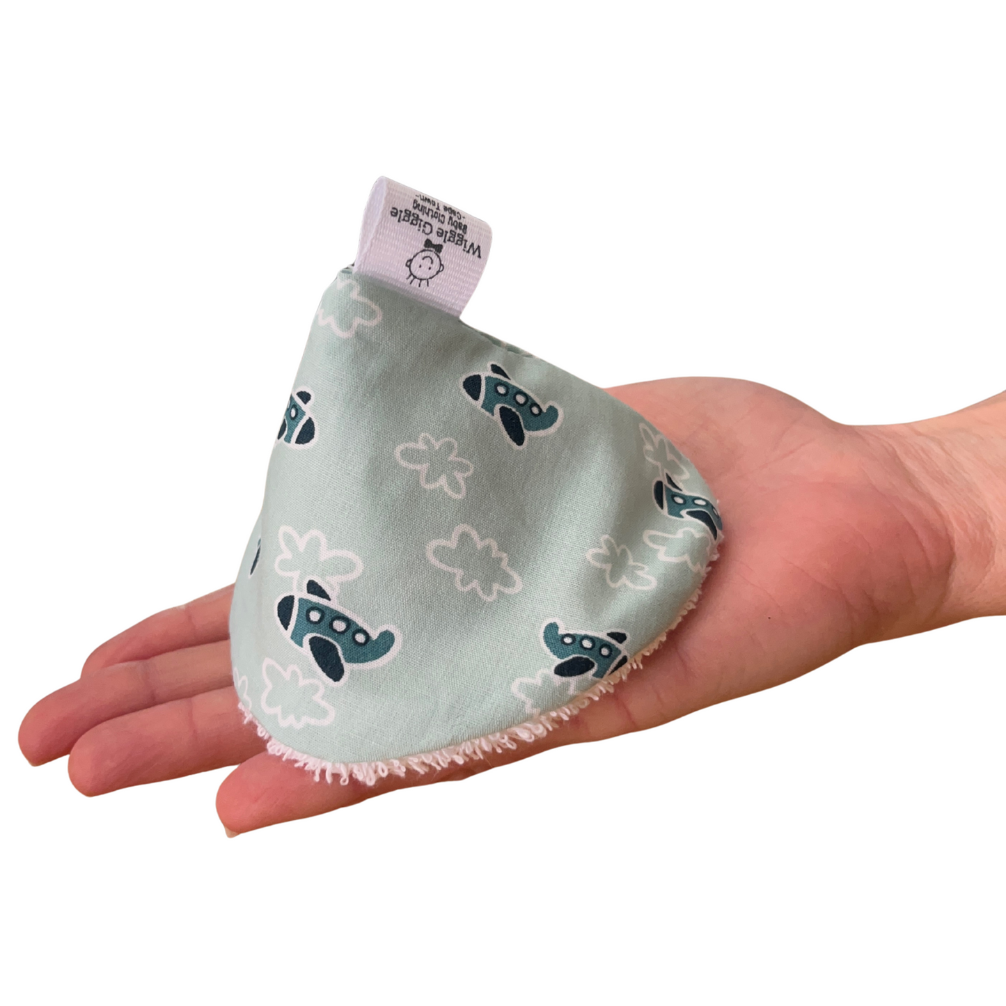 Baby boy pee pee teepee with aeroplane pattern held in a hand on a white background